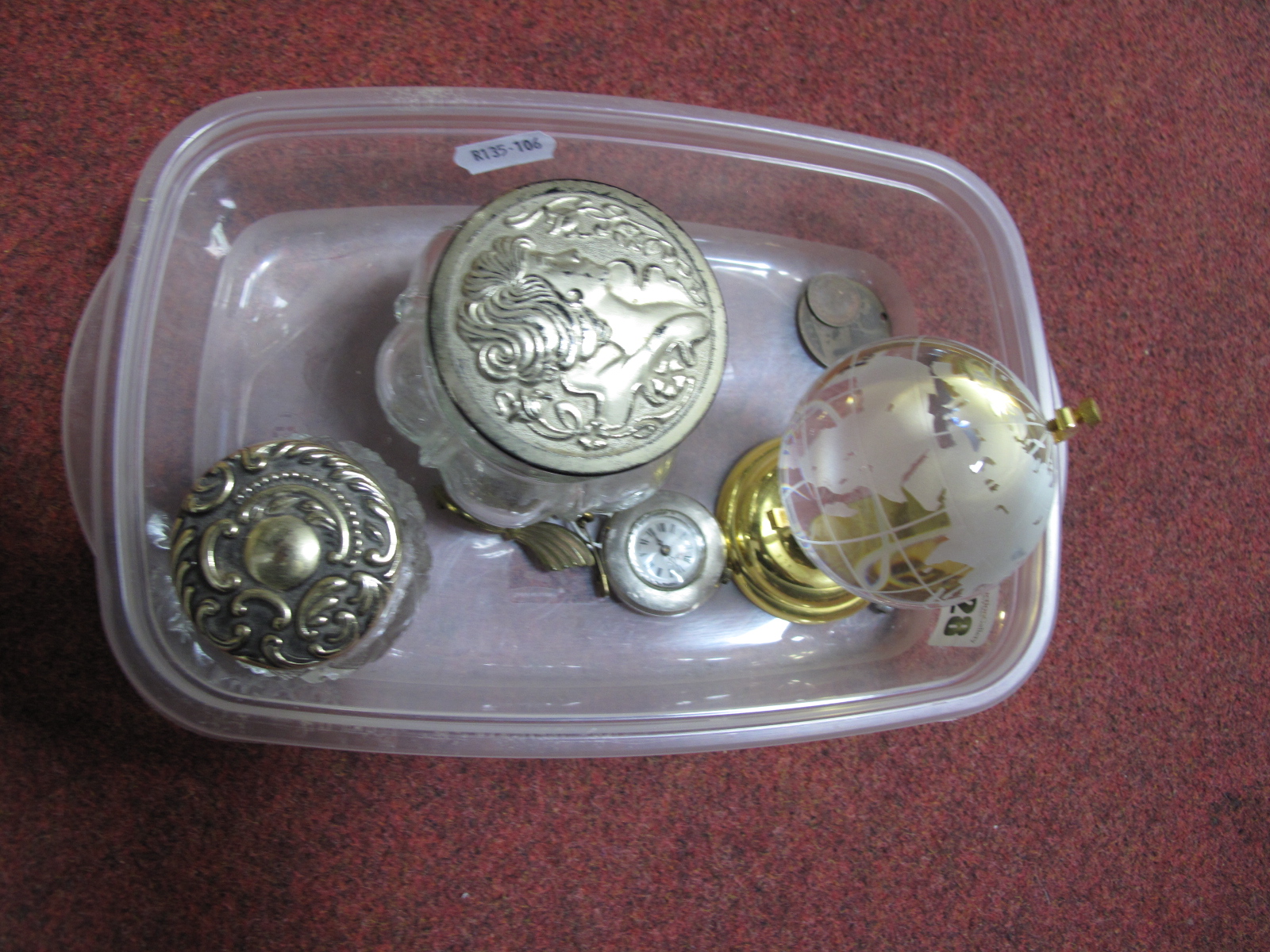 A Miniature Ornamental Globe, two Avon ornate lidded glass jars, a vintage bow bar brooch,