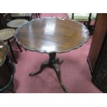 An XX Century Mahogany Pedestal Table, with a scalloped edge, turned pedestal carved cabriole legs.