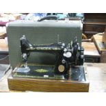 A Singer Sewing Machine, (cased).
