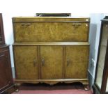 A Walnut Drinks Cabinet, circa mid XX Century with pull down front revealing Maple leaf and mirrored