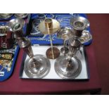 A Decorative Pair of Plated Candlesticks, detailed with ribbon tied swags, the tapering column on
