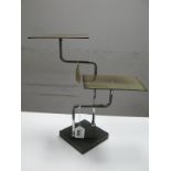 An Art Deco Shoe Display Stand, with twin rectangular plates on chrome support, on square bakelite