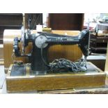 Singer Sewing Machine, in oak domed case.