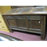 An XVIII Century Oak Coffer, with three panelled top and fascia having wavy carving above, on