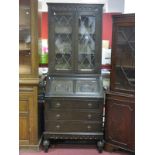 An Oak Bureau Bookcase, top with glazed, leaded doors, fall front fitted interior, three long