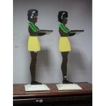 A Pair of Vintage Butler's Stands, as Caribbean ladies holding trays, one with a brass bass ashtray,