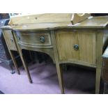 An Edwardian Inlaid Mahogany Bow Fronted Sideboard, with a central drawer, flanking cupboards, on