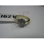 An 18ct Diamond Set Cluster Ring, with claw set brilliant cut stones, between tapered shoulders,