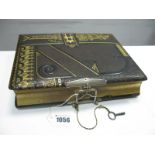 A Late XIX Century Leather Bound Photograph Album, with musical movement playing two airs, the pages