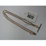 A 9ct Rose Gold Flat Curb Link Chain, suspending T-bar pendant, to swivel style fastener.