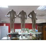 Three Gold Coloured Fibre Glass Mannequins, on glass and chrome base, approximately 98cm high. (3)