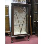 A XX Century Mahogany Glazed Cabinet, with a low back, with a glazed door, on claw ball feet.,