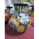 A Moorcroft Pottery Vase, painted with a stained glass window design in purple, green and tan,