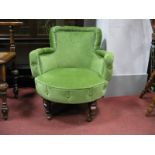 A XIX Century Nursing Chair, upholstered in green fabric on turned fore front legs.
