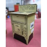 A 'Revo' Electric Co. Ltd Tinplate Cooker Savings Bank, height 14cm.