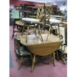 Ercol Drop Leaf Table, on four splayed legs, united by 'X' stretcher and four Fleur De Lys backed