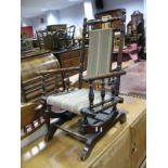 An Early XX Century American Child's Rocker, with a upholstered back and seat, on turned rockers.