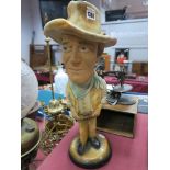 A Painted Plaster Caricature Model of John Wayne, on circular foot, height 43cm.