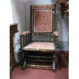 An Early XX Century American Rocking Chair, with an upholstered top rail, back, arms seat, on turned