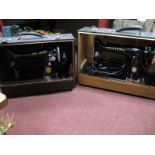 Two Singer Sewing Machines, in reptile skin effect cases.