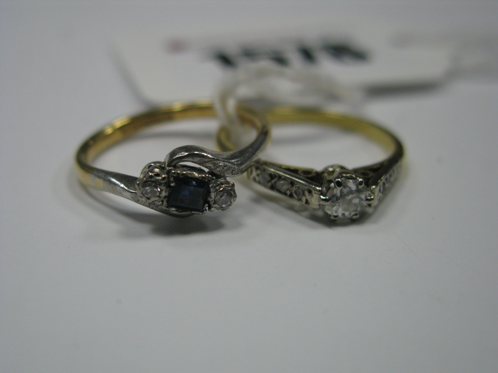 An Art Deco Style Ring, alternately claw set highlights, within twist shoulders, stamped "18ct&
