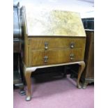 A XX Century Walnut Bureau, with a fall front, fitted interior, two long drawers on cabriole legs,