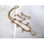 A Fancy Link Necklace, suspending integral claw set oval cabochons, with a matching