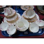 An Early XX Century Floral China Tea Service, of forty pieces with wavy gilt rims.