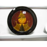 A Studio Pottery Plate, with a black rim, depicting a cubist style figure of a clown, with impressed
