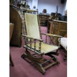 Late XIX Century American Rocking Chair, with upholstered back and seat on rockers.