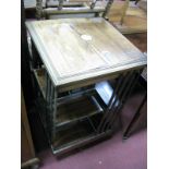 An Early XX Century Rosewood Revolving Bookcase, with a square inlaid top, open shelves an quarter