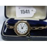 A 9ct Gold Cased Ladies Wristwatch, the unsigned white dial with Arabic numerals, in octagonal case,