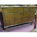 A XX Century Walnut Sideboard, with a low shaped back, two small drawers over cupboard doors, on