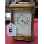 A Brass Cased Carriage Clock, with Corinthian columns between bevelled glass panels, floral