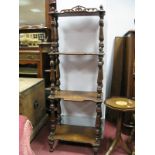 A XIX Century Walnut What Not, with four inlaid shelves, on shaped shelves on turned supports.