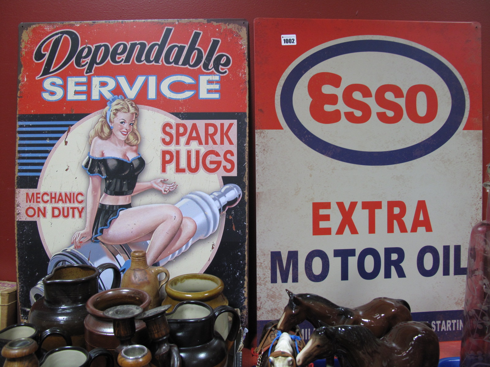 Two Metal Wall Signs 'Dependable Service Spark Plugs' and 'Esso Motor Oil', 70 x 50cm each. (2)