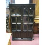 An Oak Display Cabinet, with knulled decoration, glazed doors with linen fold decoration.