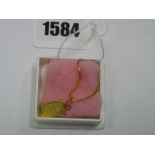 A "Suisse 1g Fine Gold 999.9" Ingot Pendant, depicting rose design, on fine chain, stamped "750".