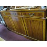 Yew Wood Sideboard, with a crossbanded top, three top drawers over cupboards, on bracket feet, 15.