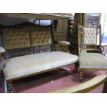 An Edwardian Mahogany Salon Settee with a shaped top rail, upholstered back, arms and seat, on