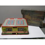 A Post War West German Tinplate Fire Station, with two plastic fire engines, in poor box and one