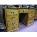 A Pine Kneehole Desk, with gilt tooled scriver to top, central drawer flanked by two flights of four