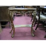 A Gilt Shaped Side table, on scroll sabre legs, united by undershelf.