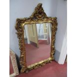 An Italian Gilt Framed Wall Mirror, with shell and scroll border 104 x 70cm