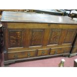 An XVIII Century Oak Mule Chest, with moulded edge to hinged top, four panelled base over three