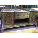 A 1920's Mahogany Bow Fronted Sideboard, with low back, end cupboards, flanking twin drawers over
