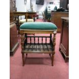 An Edwardian Walnut Piano Stool, with spindle supports, undershelf and splayed feet.