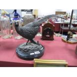 A Cast Metal Model of a Pheasant, length 33cm, on a circular streaked marble plinth.
