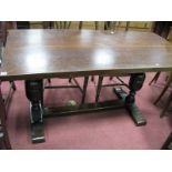 An Oak Refectory Table, rectangular top on cup and cover stretched supports, length cm.