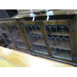 A Pair of Jaycee Oak Book Cases, each with honeycomb lead glazed doors and butterfly wing hinges,